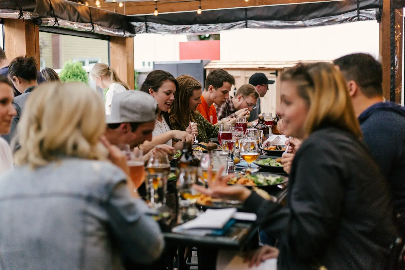A long table of people sharing dinner