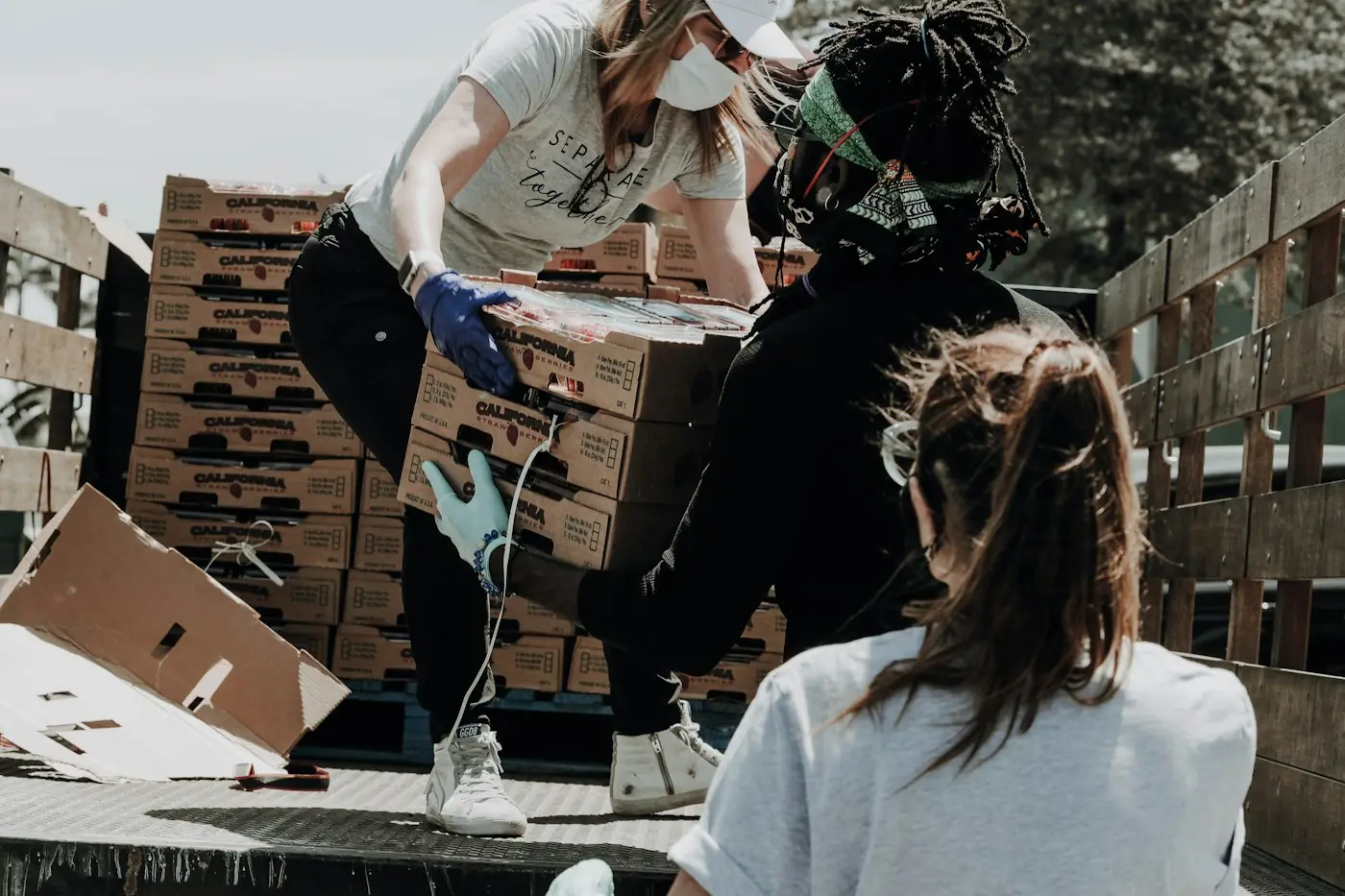 Volunteers unloading boxes at a food drive