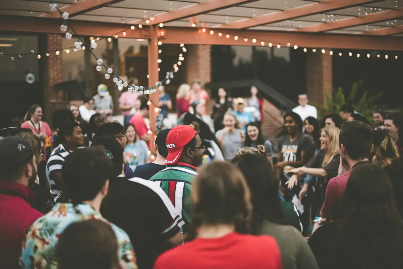 A crowd of members at an outdoor evening gathering